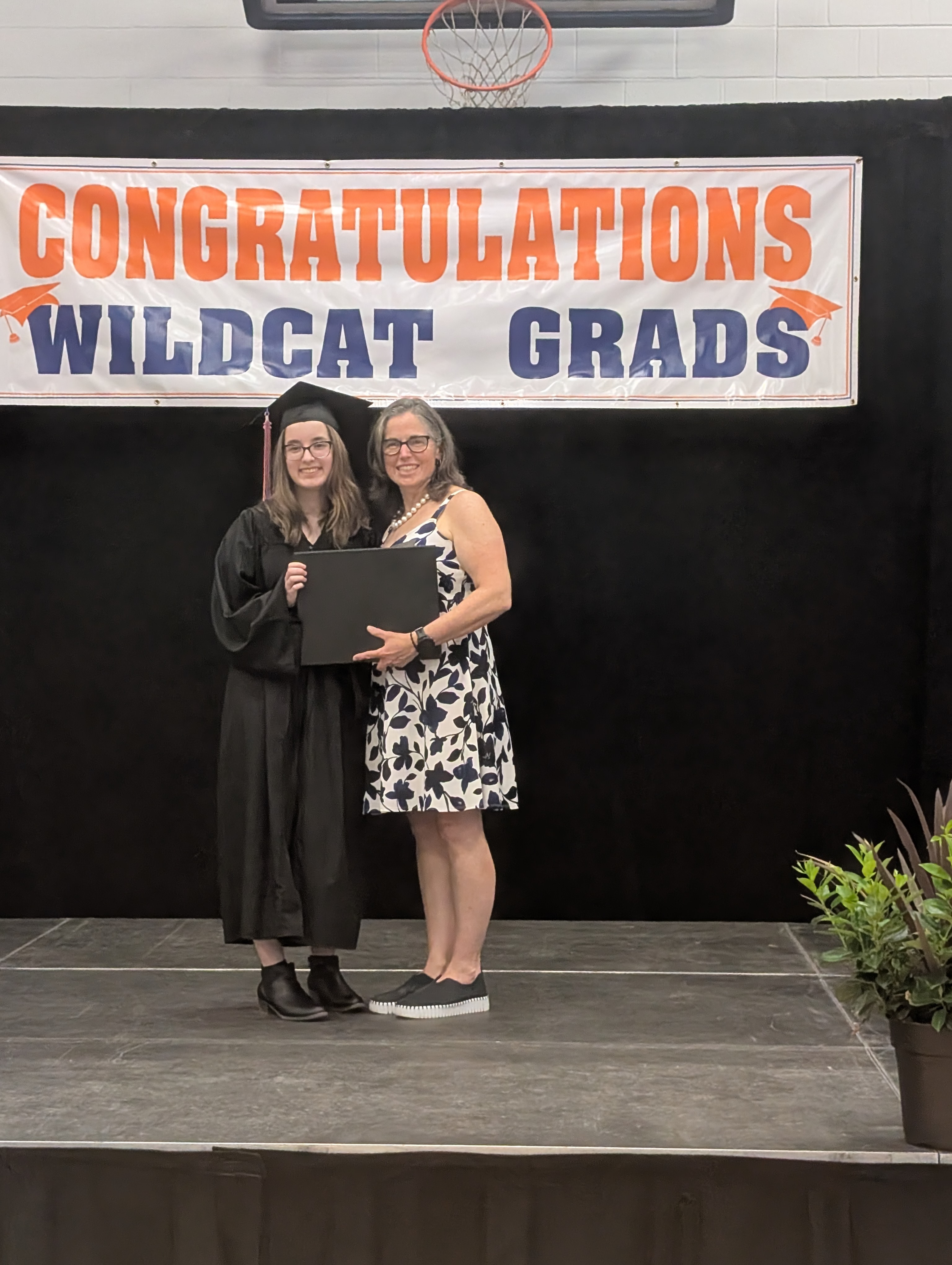Natalie receiving her diploma on stage at graduation